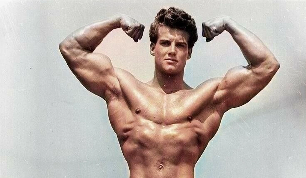 Young Steve Reeves, actor and bodybuilder, showing his muscular body